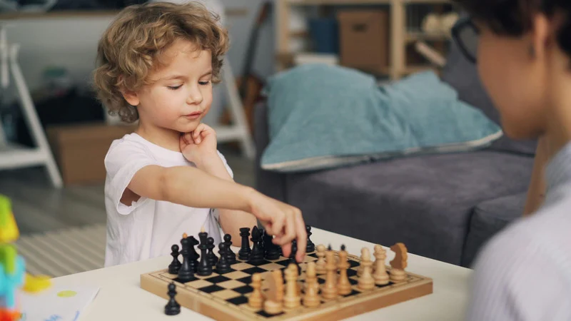 Child playing chess indoors