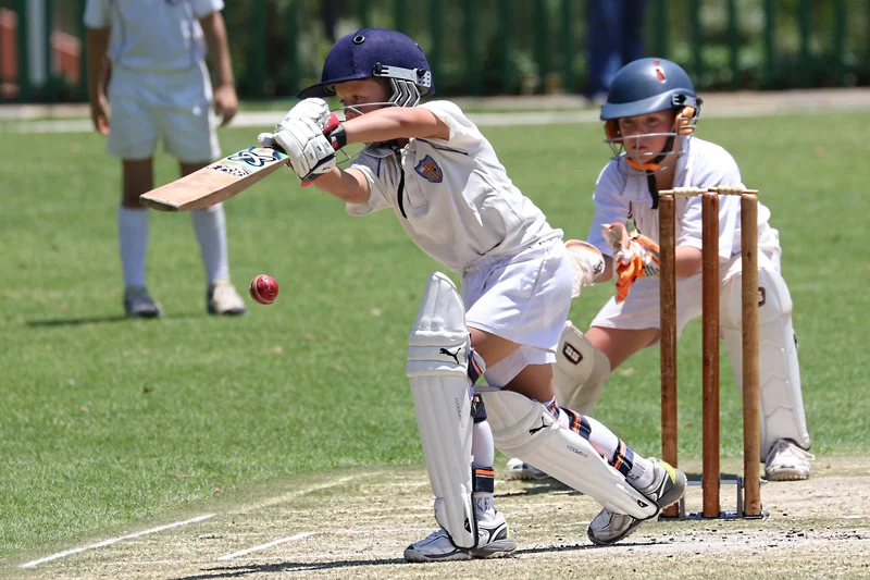Boy playing a sport outdoors