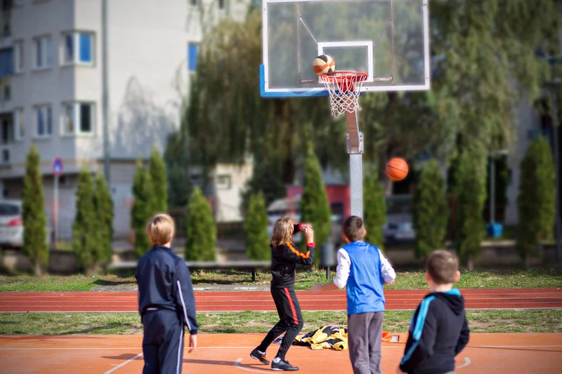 Children playing basketball outdoors